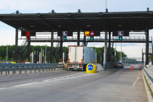 Pay point on toll road, truck and car paying fare at toll gate