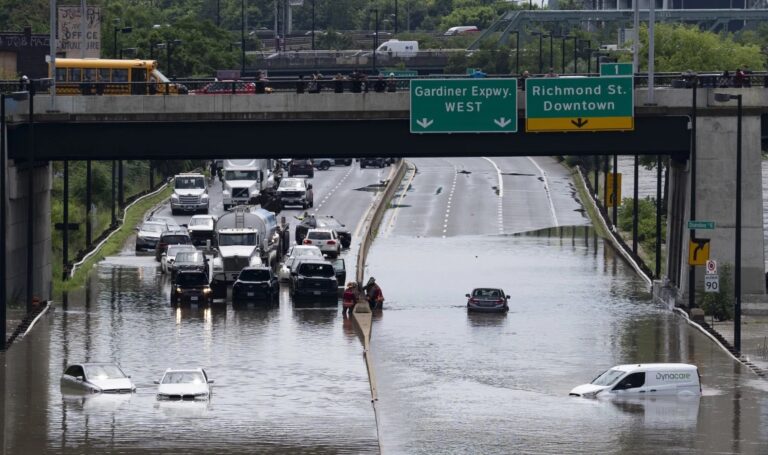 A major highway and roads are flooded as torrential rains hit Canada’s largest city