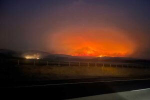 In this image provided by the Oregon Department of Transportation, the Durkee fire burns in the background as it nears Interstate 84 near Huntington, Ore., early Tuesday, July 23, 2024. (Oregon Department of Transportation via AP)