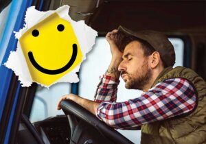 Sad driver in truck with smiley face bursting through the photo