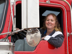 Female truck driver in a big rig.