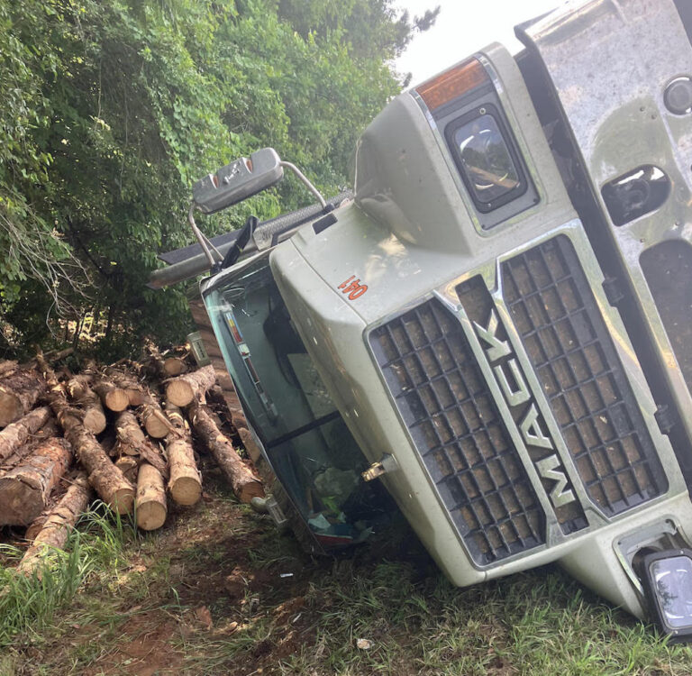 Log truck overturns after near head-on collision with semi-truck in west Georgia