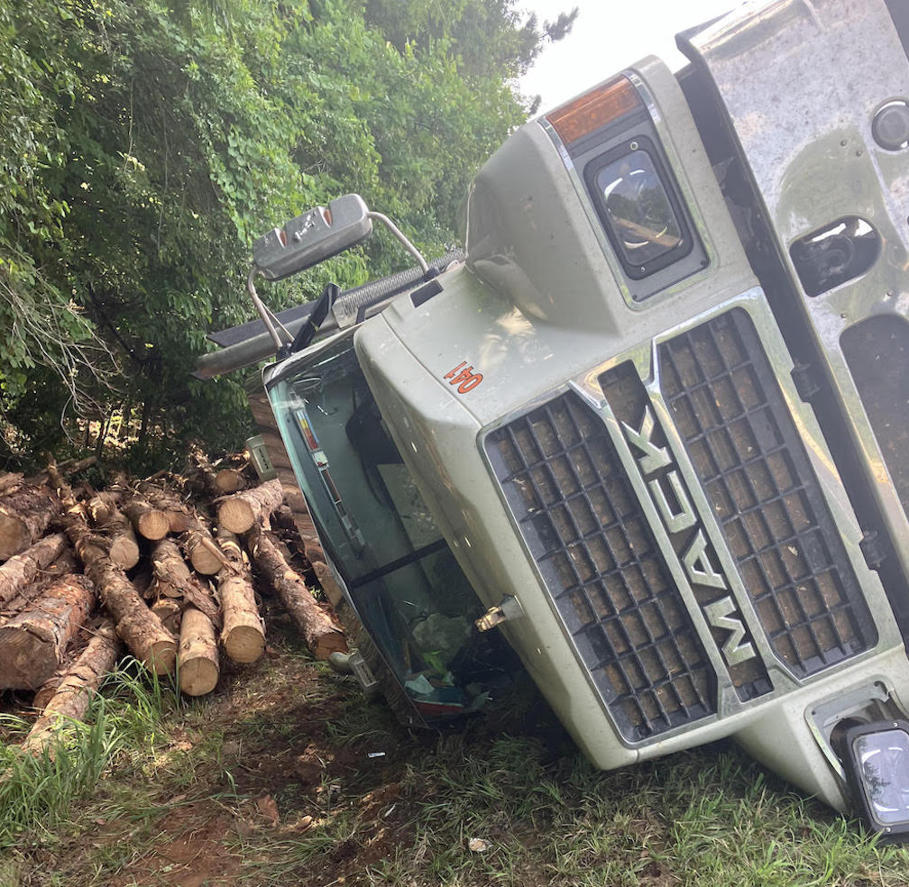 Log truck overturns after near head-on collision with semi-truck in ...