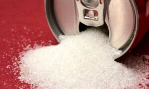 Sugar pouring out of cola can