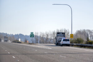 Police stopped big rig semi truck for inspection on the highway exit