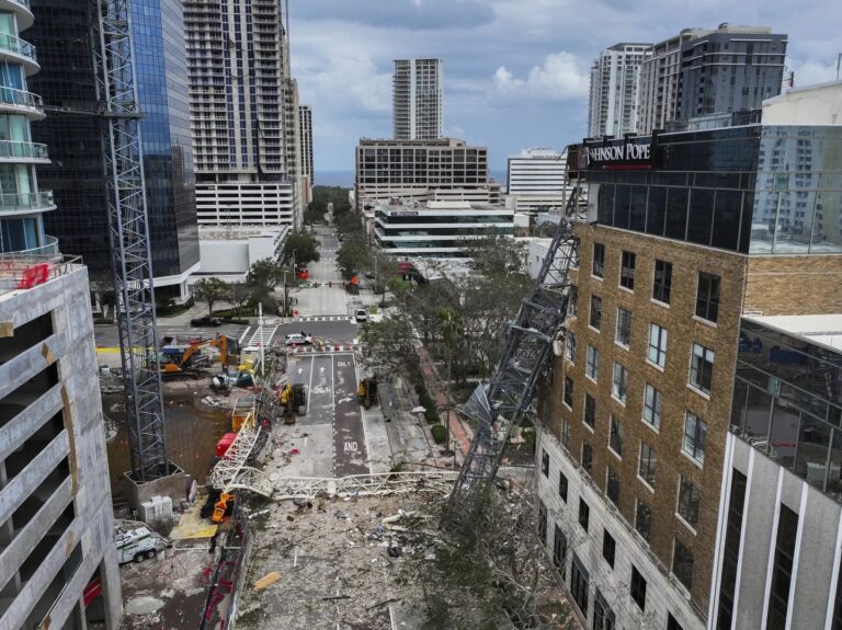 Residents slog through flooded streets, clear debris after Hurricane Milton tore through Florida