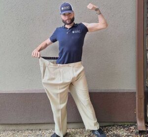 Garrett Steenblik shows the pants he wore before losing 200 pounds