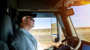 Close up of driver's hands on big truck steering wheel