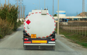 Tanker truck for transporting fuels arriving at a loading plant, with fuel storage tanks.