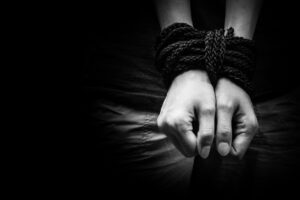 Hands of a missing kidnapped, abused, hostage, victim woman tied