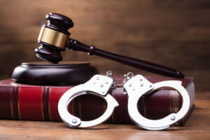 Gavel And Handcuffs On Law Book