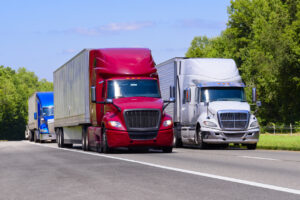 Red, White, and Blue Trucks On Interstate With Copy Space