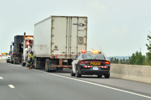 (OPP) Ontario Provincial Police Car, Tow Trucks and Semi Truck stopped on shoulder of Highway 401