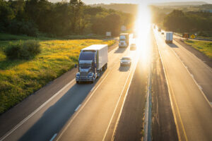 Semi trucks 18 wheelers on highway at sunset view from above