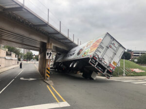 14 September 2019 Durham North Carolina USA view of the back of the track wheels of a skidded overturned truck on an highway in an accident hits bridge