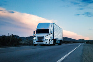 At sunset, a white semi truck rumbled through the vast Nevada Desert. Against the majestic backdrop of mountains, it pressed on, leaving tire tracks on the desert floor.