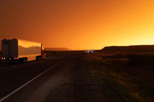 Truck on highway at sunset