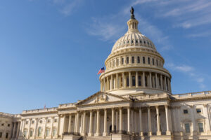 The United States Capitol building with the American flag flying atop its flagpole, Washington DC