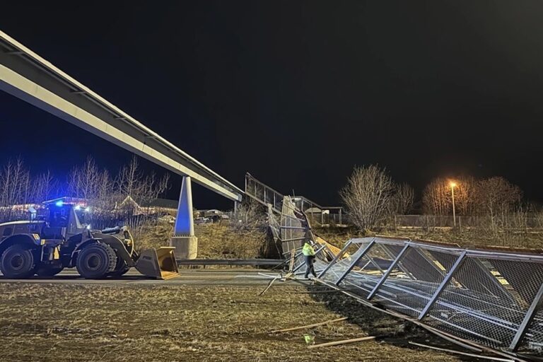 Fencing, roof of Anchorage pedestrian bridge fall in strong wind, closing highway