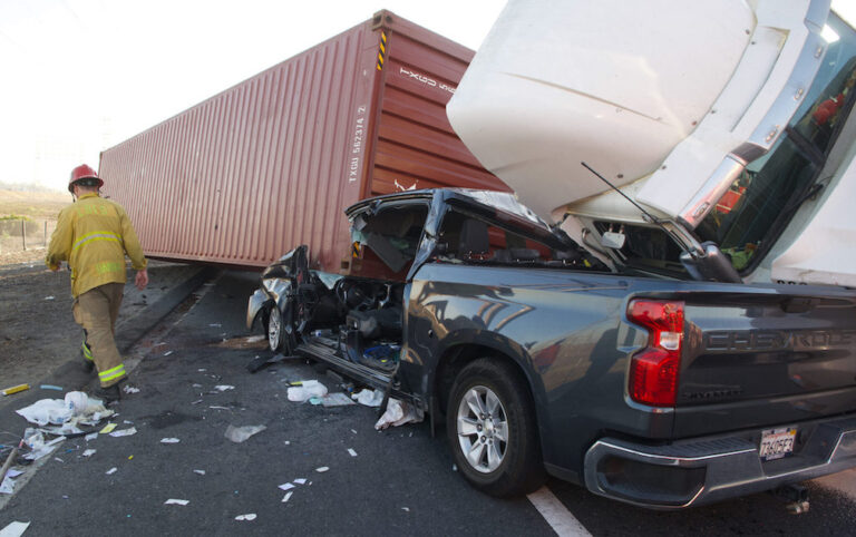 Two rescued after semi tips over on top of pick-up truck