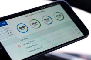 Electronic logging device for trucking industry with hours of service displayed on smartphone screen