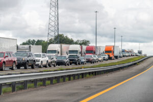 Interstate highway i95 driving car pov near Jacksonville, Florida and long line traffic jam of many trucks vehicles stuck due to accident on road