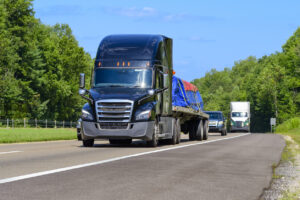 Flatbed Eighteen Wheeler Semi With Load of Heavy Machinery