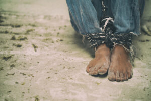 hopeless man feet tied together with rope