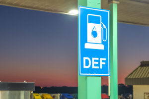 Diesel exhaust fluid or DEF sign posted in a truck stop, next to fuel pump