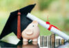 piggy bank With Graduation Cap on black glass floor,Money saving concept.