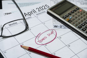 2024 US taxes due calendar reminder with tax forms calculator and glasses