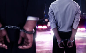 Two businessman in handcuffs